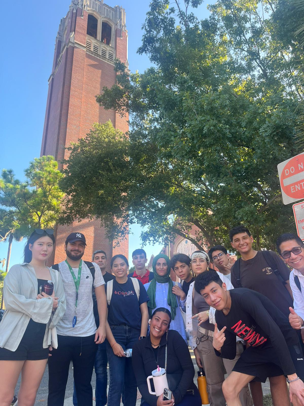 Students posing in front of a tower.