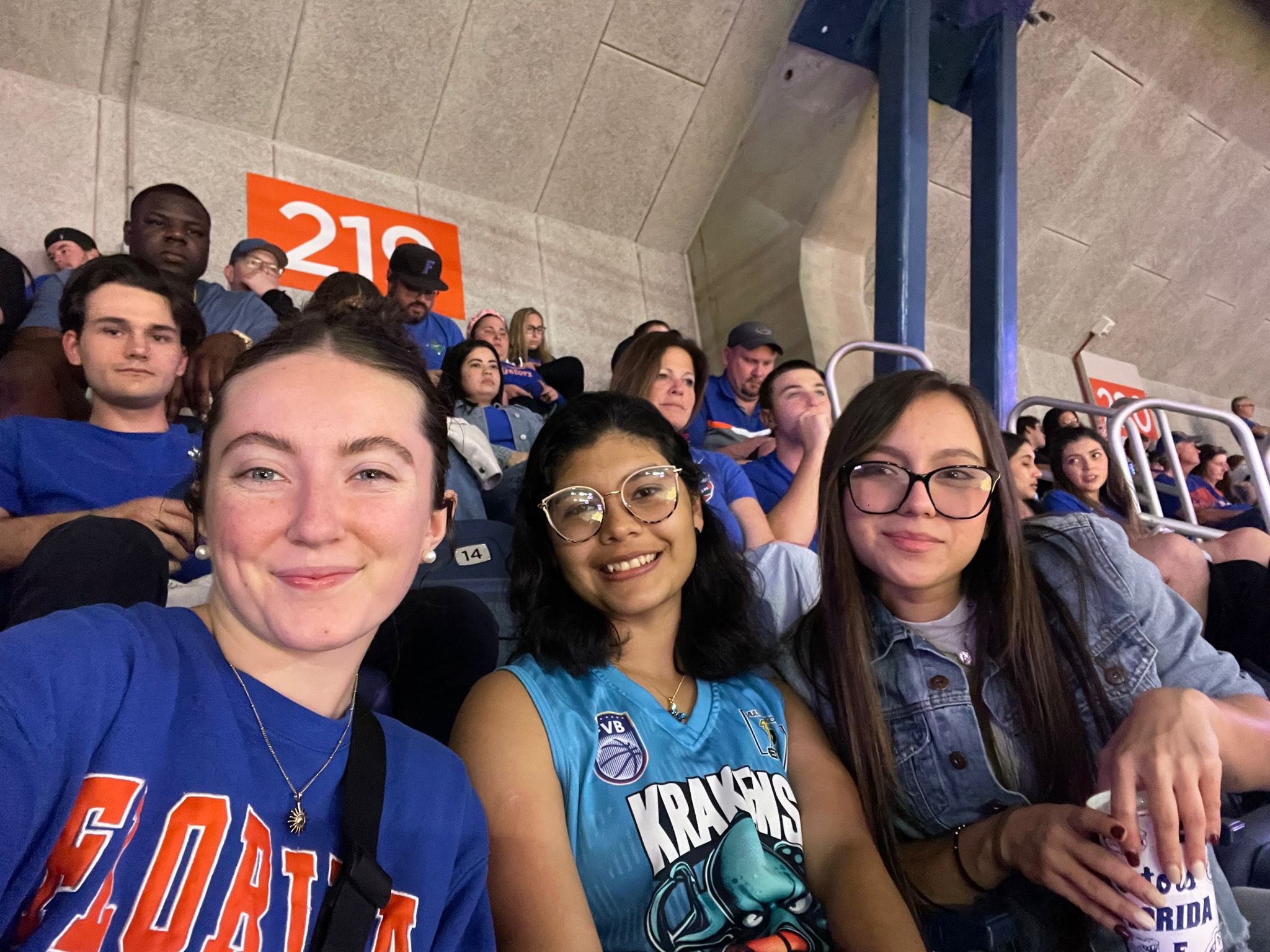 Students in orange and blue at the basketball game