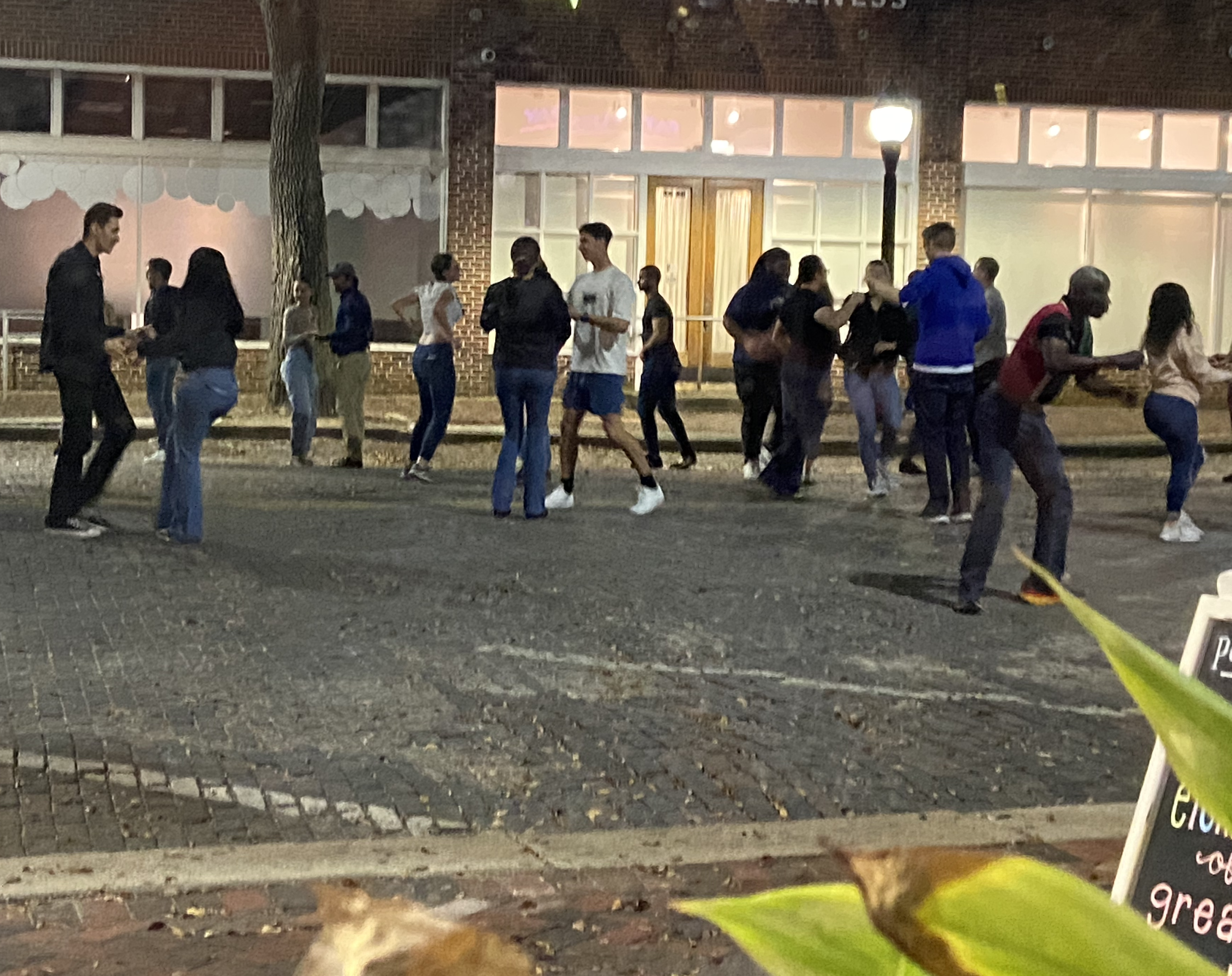 Beginning Salsa dancers in the street on a warm evening.