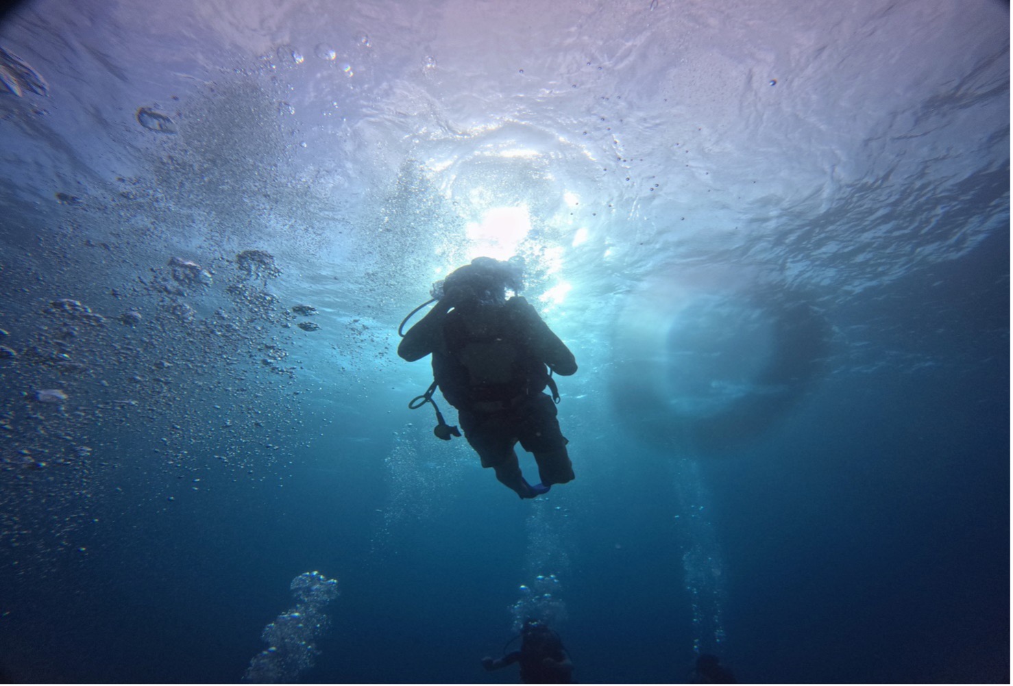 Scuba diver in deep blue crystal-clear water